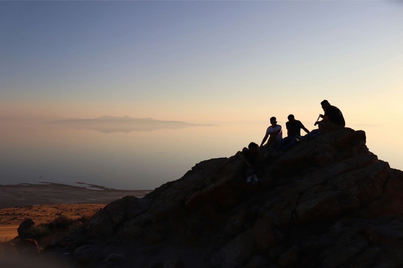 A group of people climbing up the side of a mountain.